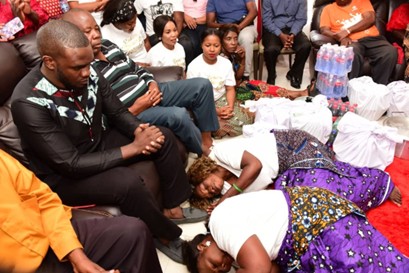 Women laying down and presenting food to men.